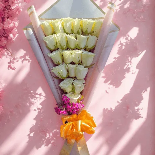 White Rose Cone Bouquet with Golden Bow & Touch of Pink